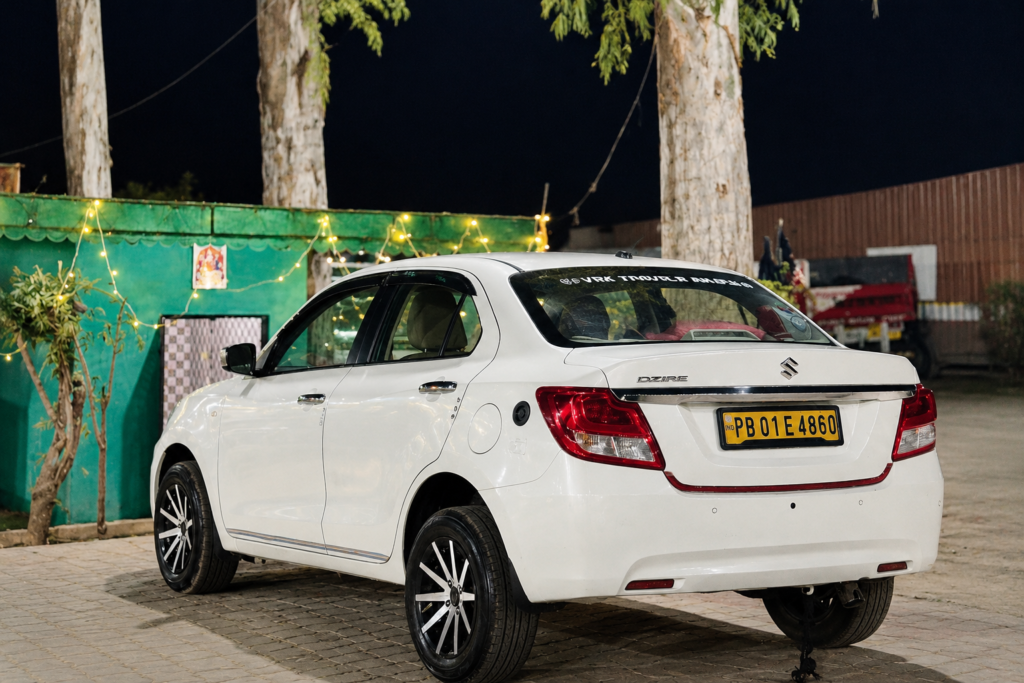 White Dzire Under Festive Night Lights